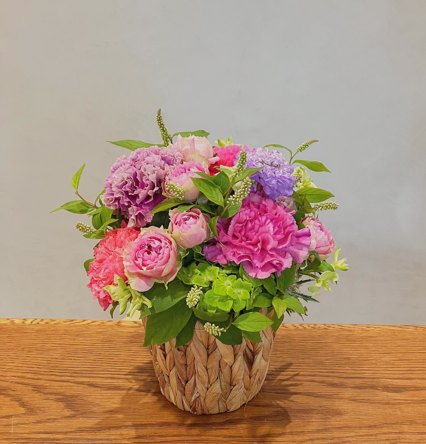Hand holding mixed flowers bouquet